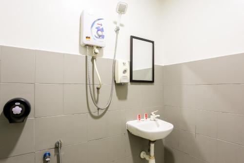 a bathroom with a sink and a shower at Hotel O Kl2f Rest & Go in Shah Alam