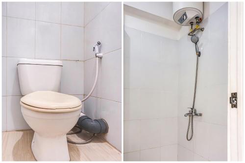 a bathroom with a toilet and a shower at OYO 90949 Apartement Cibubur Village Kaisar Property in Depok