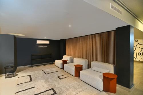 a waiting room with two chairs and a table at Circa Aparthotel by Totalstay in Pretoria