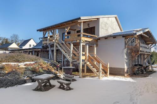 a house under construction with a bench in front of it at Fewo am Flämingrand in Zahna-Elster