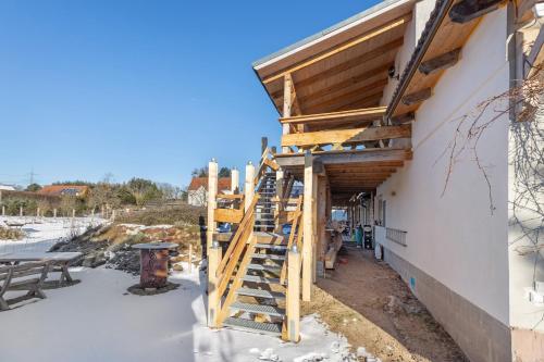 a house being constructed with wooden stairs on the side at Fewo am Flämingrand in Zahna-Elster