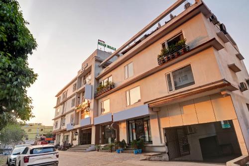 a building with a car parked in front of it at Treebo Moon Waalk, Patia in Bhubaneshwar