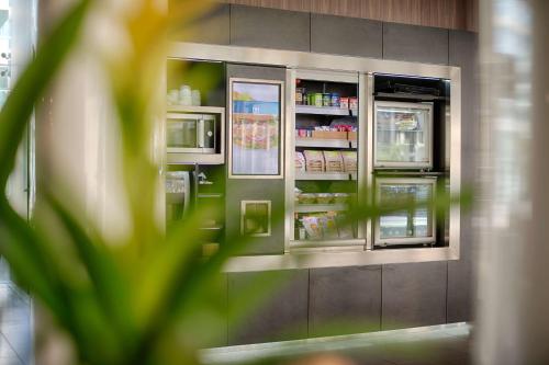 a refrigerator is shown with its doors open at NH Savona Darsena in Savona
