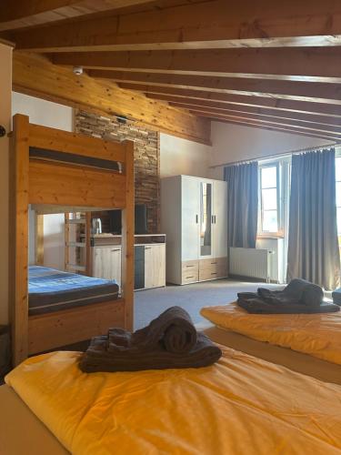 a room with two bunk beds in a building at Touristenheim Bergfreude in Leukerbad