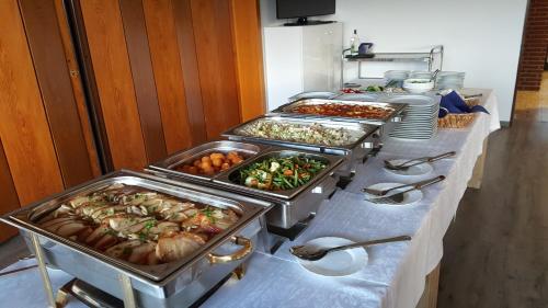a buffet line with many different types of food at Hotel Restaurant Teichaue in Adendorf