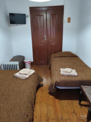 a room with two beds and a wooden floor at Casa D'Avó Mila in Góis