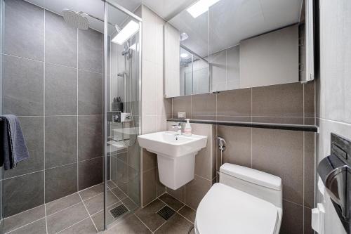a bathroom with a toilet and a sink and a shower at Urbanstay Sokcho Deungdae Beach in Sokcho