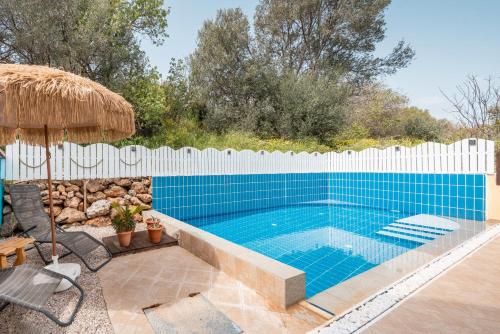 a swimming pool with a white fence around it at Villa May Rose in Kalathos
