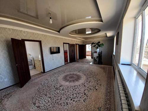 a hallway with a rug on the floor of a room at Beksultan guest house in Epkin