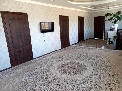 a room with a large rug on the floor at Beksultan guest house in Epkin