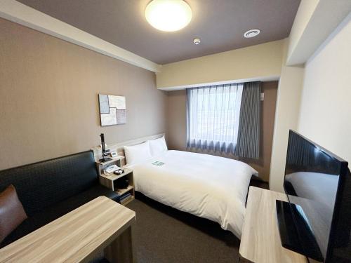 Postel nebo postele na pokoji v ubytování Hotel Route-Inn Takefu Inter
