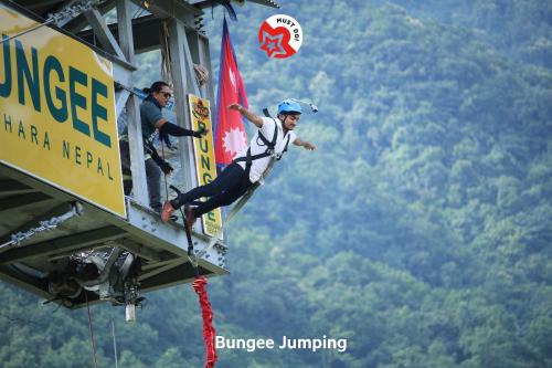 two men are rappelling off of a gondola at OYO 123 Hotel Prince Plaza in Kathmandu