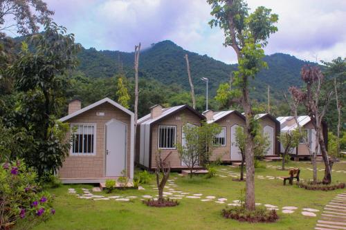 a row of houses with mountains in the background at Halo Retreat in Hòa Bình
