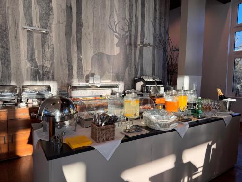 a buffet table with glasses of orange juice and drinks at Hotel Spirodom in Admont