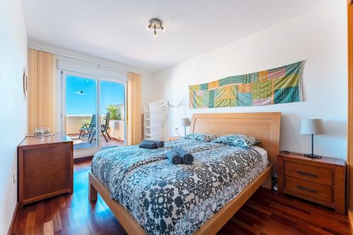 a bedroom with a bed and a view of the ocean at Las Terrazas in La Cala de Mijas