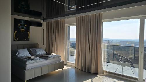 a bedroom with a bed and a large window at Apartament dla dwojga z jacuzzi na wyłączność in Świecie