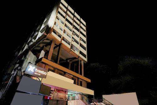 a tall building with a sign in front of it at Treebo RVG, Alkapuri in Vadodara