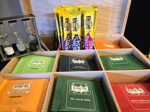 a wooden box filled with different colored labels at Hôtel Le SAINT-GENIÈS in Uzès