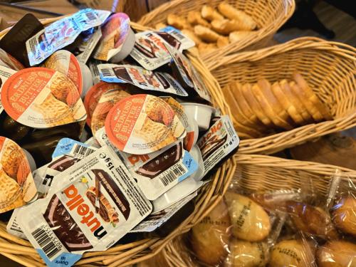 a bunch of baskets filled with different types of bread at Hôtel Le SAINT-GENIÈS in Uzès