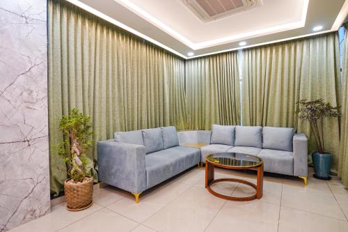 a living room with a couch and a table at Oriva Freshco in Bengaluru