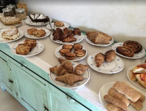 a table topped with plates of pastries and pies at Wp RELAIS LOCANDA FIORE DI ZAGARA in Diso