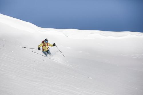 a person is skiing down a snow covered slope at Valbella Resort in Lenzerheide