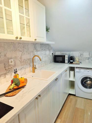 a kitchen with a sink and a plate of vegetables at Blue Promenade Apartments in Dubrovnik