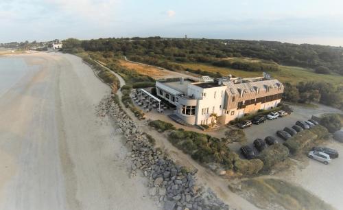 an aerial view of a house next to a beach at Logis Hôtel & Restaurant LES MOUETTES - Larmor Plage, Proche de LORIENT in Larmor-Plage