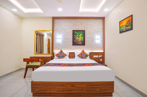 a bedroom with a large bed and a desk at Oriva Freshco in Bengaluru