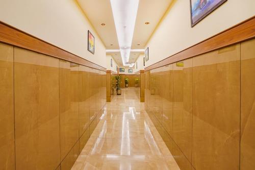 a hallway in a building with wooden walls and a long corridor at Oriva Freshco in Bengaluru