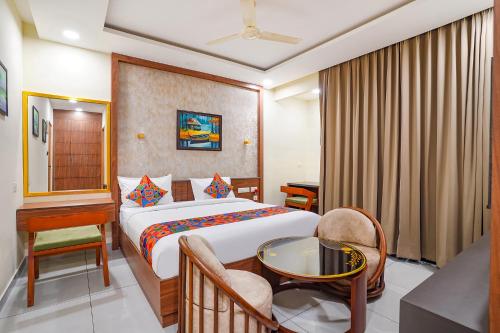 a hotel room with a bed and a table at Oriva Freshco in Bengaluru