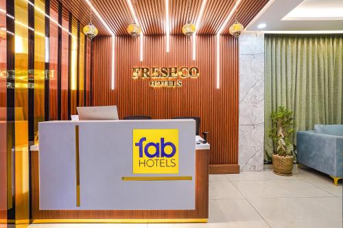 a reception desk in a lobby with a ibidh holds sign at Oriva Freshco in Bengaluru