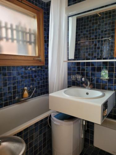 a bathroom with a sink and a mirror at Studio Colina 206 in Leysin