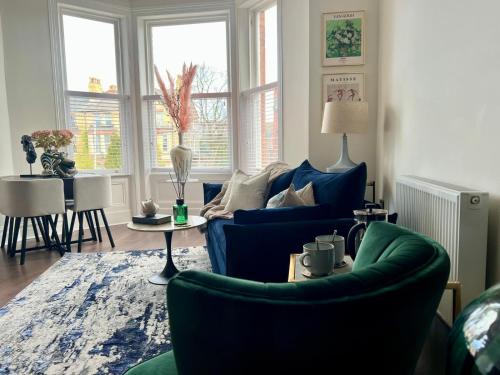 a living room with two blue chairs and a table at No 50 - 2nd Floor Beautiful one bed apartment in Liverpool Sleeps 4 in Liverpool