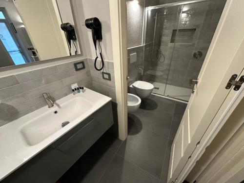 a bathroom with a sink and a toilet and a shower at S. Andrea in Vercelli