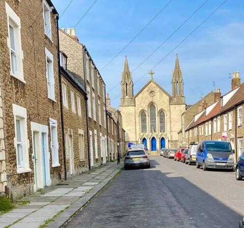 a street with cars parked on the side of a building at Cottage in the Heart of Frome in Frome