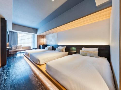 Postel nebo postele na pokoji v ubytování Mitsui Garden Hotel Ginza-gochome
