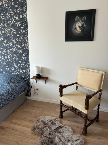 a bedroom with a chair and a bed at Superbe pavillon 4 chambres - parking privé - Grande Terrasse au calme - limoges in Limoges