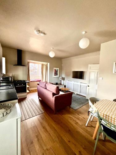 a living room with a couch and a table at Princeland Lodge in Blairgowrie