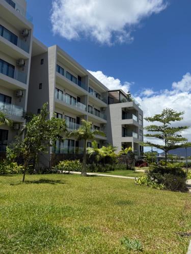 an apartment building with a lawn in front of it at Royal Green Wellness Resort in Moka