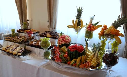 a table with many different types of food on it at Gościniec Uniejów in Uniejow
