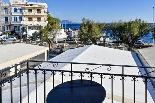 a balcony with a view of a city and the ocean at Ikaria Studios in Agios Kirykos