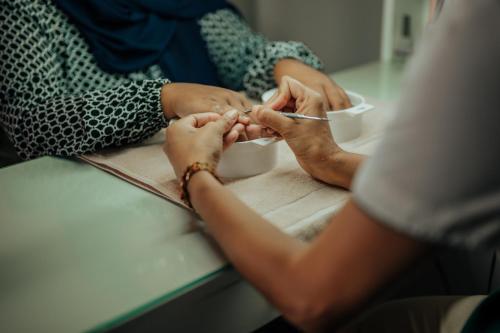 a group of people sitting at a table with their hands at Royal Green Wellness Resort in Moka