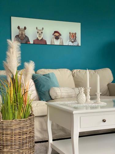 a living room with a couch and a table at Heidequartier Ferienwohnung in Bispingen