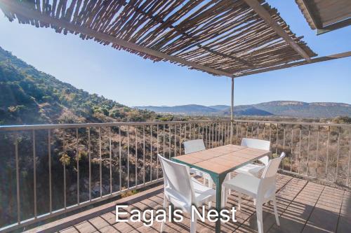a table and chairs on a balcony with a view at Thabela Thabeng in Parys