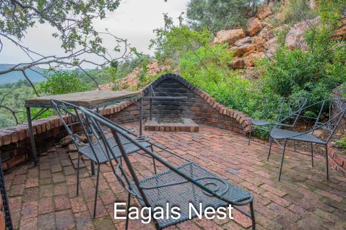 a table and chairs sitting on a brick patio at Thabela Thabeng in Parys