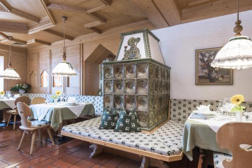 a restaurant with a bench in the middle of a room at Ferien & Wellnesshotel Windschar in Brunico