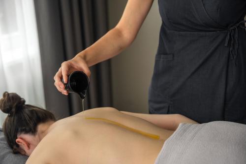 a woman getting her hair washed in a salon at Ferien & Wellnesshotel Windschar in Brunico