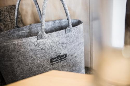 a close up of a grey tote bag on a table at Ferien & Wellnesshotel Windschar in Brunico