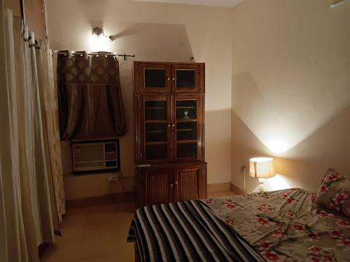 a bedroom with a bed and a dresser in a room at Geeta Villa in Lucknow